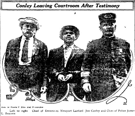 Jim Conley, center, being led away in custody after his testimony
